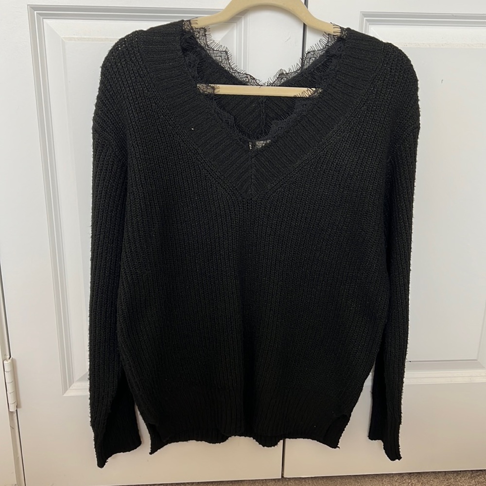 Medium black sweater. Never worn. Soft material.